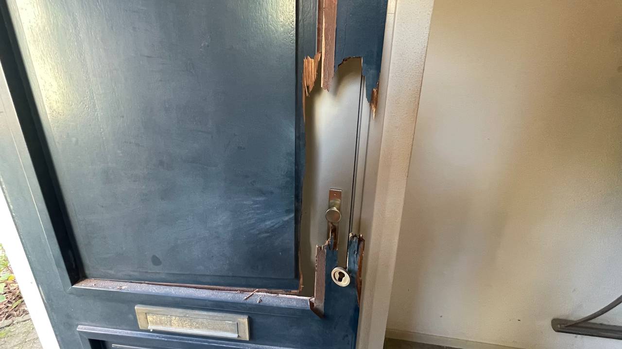 De voordeur is flink beschadigd (foto: Raymond Merkx).