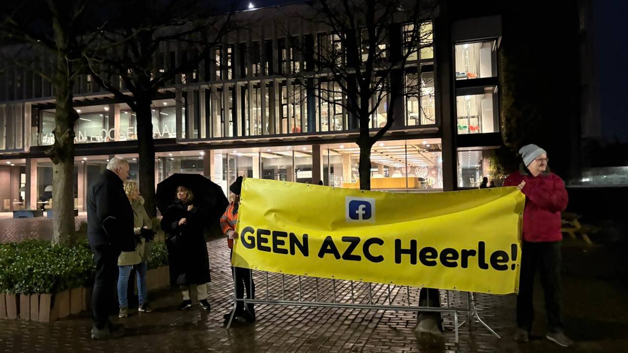 Een aantal mensen protesteert voorafgaand aan de inspraakavond tegen de komst van een azc in Heerle (foto: Erik Peeters).