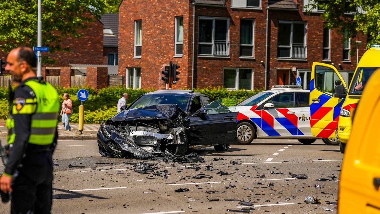 Pakketbezorger gewond bij botsing, auto schiet door naar fietspad.