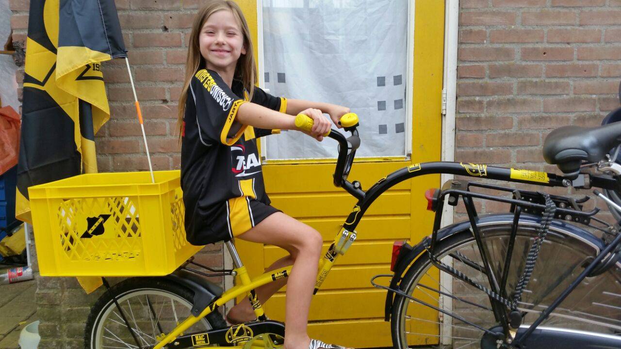 Whitney op haar nieuwe, geel-zwarte aanhangfiets.