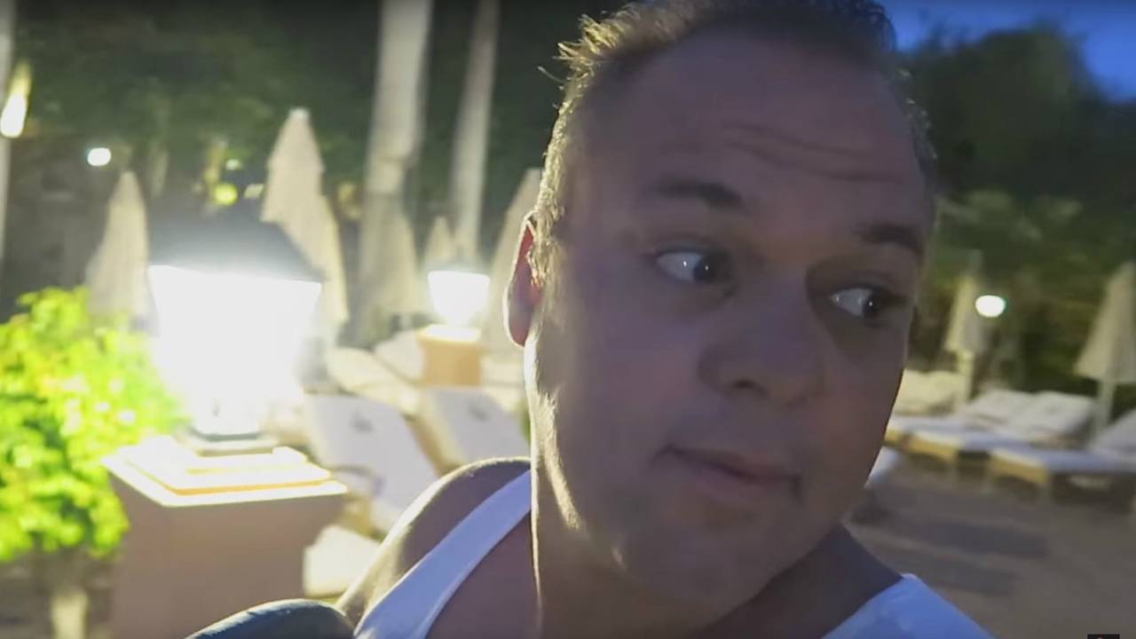 Frans Bauer zoekt in alle vroegte de juiste plek bij het zwembad op zijn vakantieresort