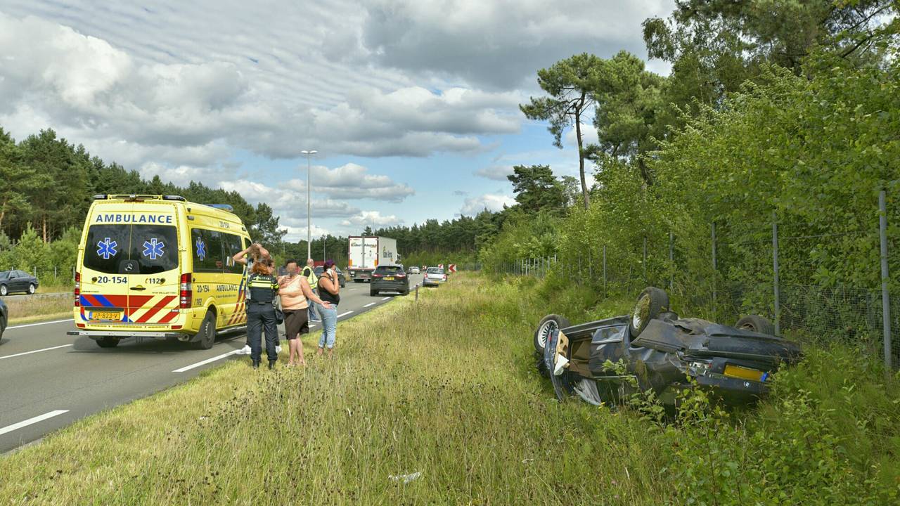 De BMW belandde ondersteboven in de greppel. (foto: Jules Vorselaars)