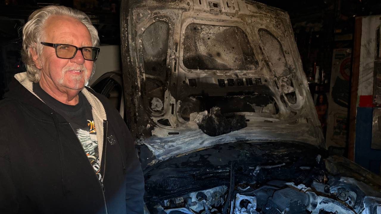 Perry bij zijn uitgebrande auto (foto: Omroep Brabant).