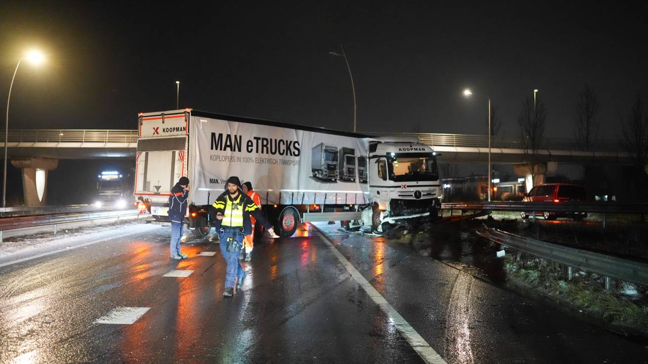 Geschaarde vrachtwagen door glad wegdek bij Waalwijk