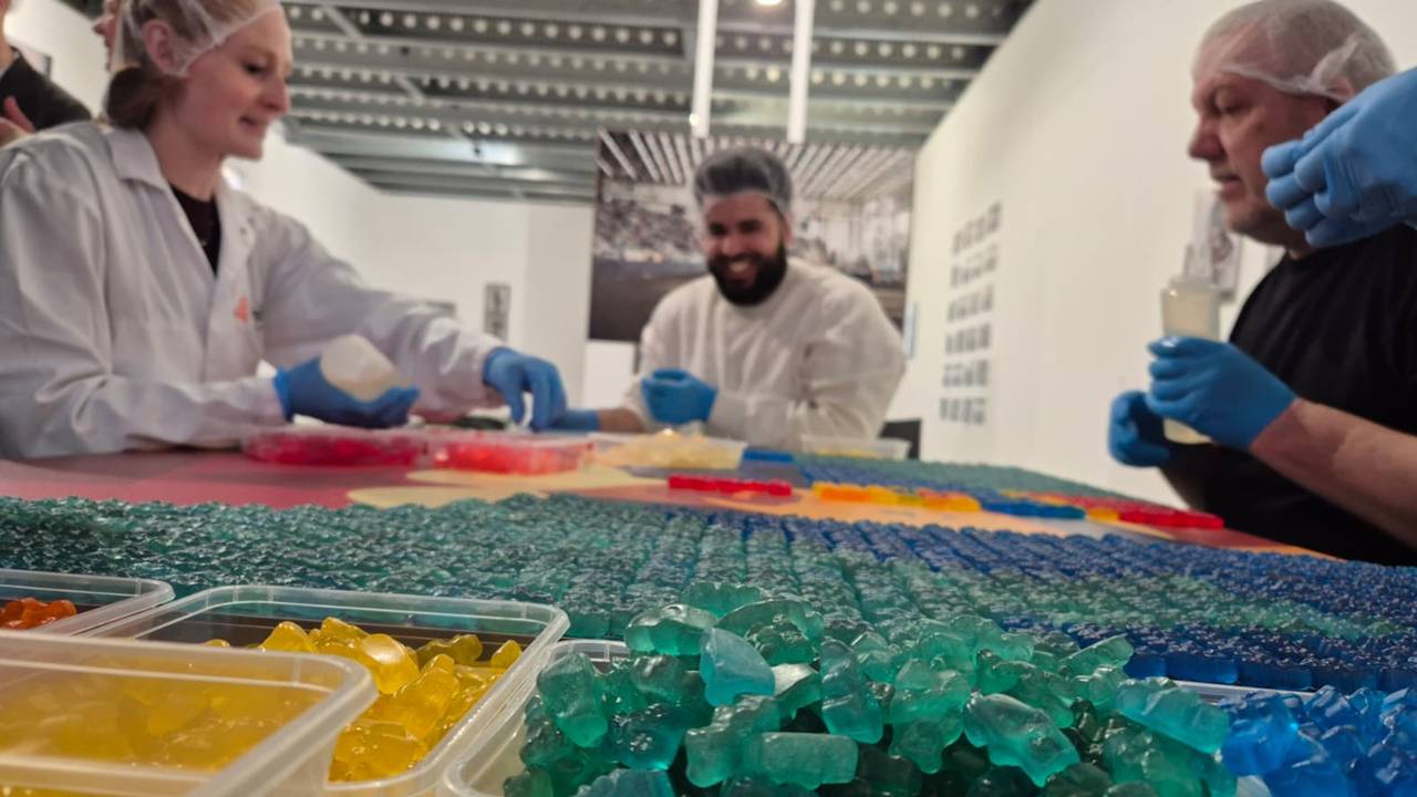 Medewerkers van Tanis zijn druk met het beplakken van het gummibeertjes-mozaïek (foto: Niek de Bruijn)