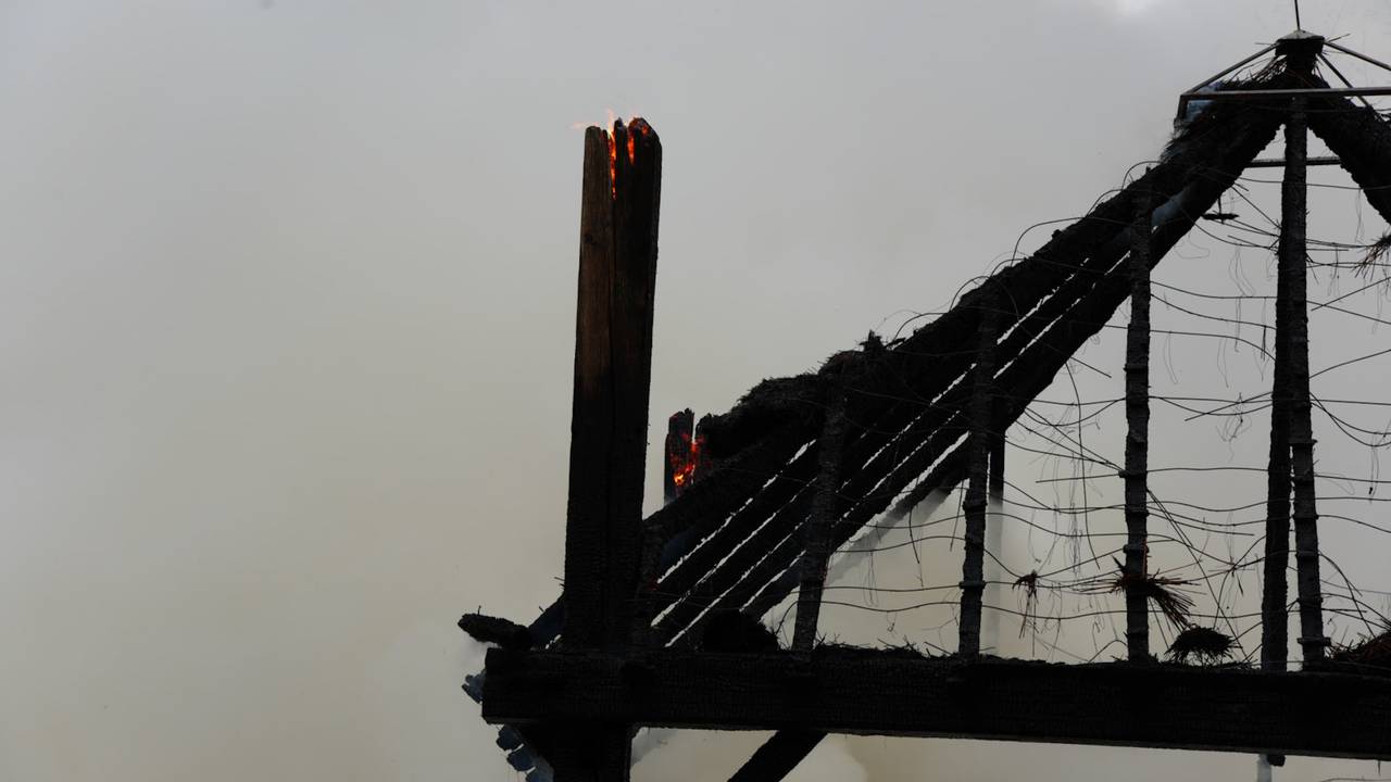 De smeulende resten hooi moeten uit elkaar getrokken worden (foto: Erik Haverhals / Persbureau Heitink).