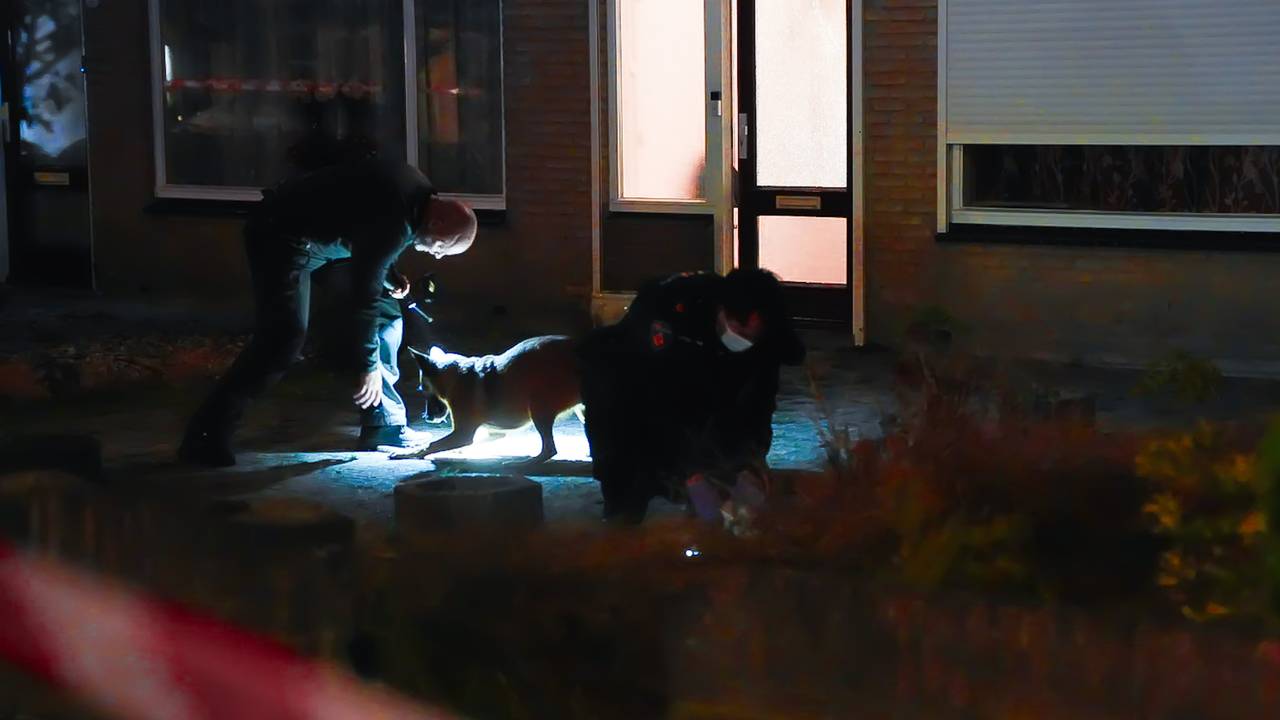 Politieagenten zoeken naar kogelhulzen (foto: Erik Haverhals/Persbureau Heitink).