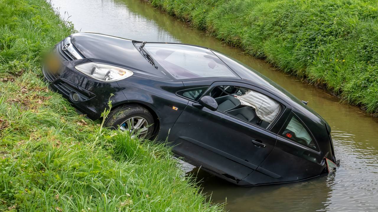 Auto belandt in Herpt in de sloot (foto: Iwan van Dun / SQ Vision)