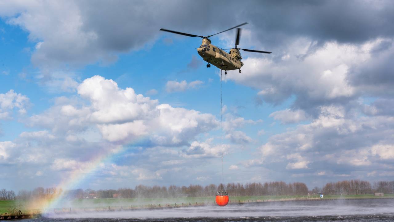Een Chinook van de Koninklijke Luchtmacht haalt water met een Bambi Bucket (foto: Defensie).