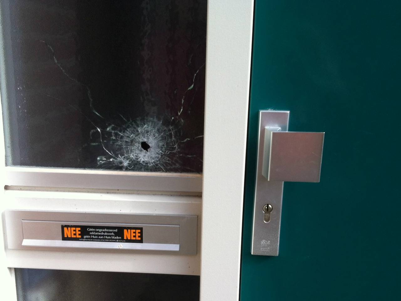 Het gat in de ruit van de beschoten woning in Heesch