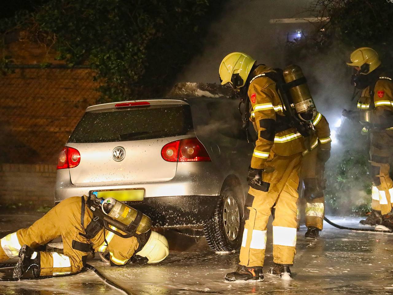 De brandweer onderzoekt de zwaar beschadigde auto (foto: SQ Vision/Gabor Heeres).