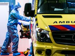 Ziekenhuismedewerkers maken een coronapatiënt gereed voor herplaatsing vanuit het TweeSteden Ziekenhuis in Tilburg. Foto: ANP