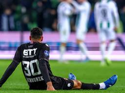 Raffael Behounek van Willem II is er na de nederlaag bij gaan zitten, terwijl Groningen-spelers een feestje vieren (foto: Orange Pictures).