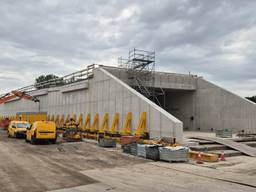 Hefwerktuigen aan de constructie tillen het gevaarte op rails (archieffoto: Niek de Bruijn).