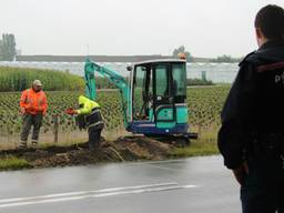 Met een graafmachine werd gezocht naar het lek. (Rick de Haan/Stuve Fotografie)