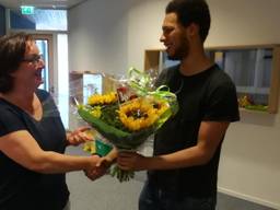 Viviane Blom van De Ontdekking krijgt bos bloemen van Chris Artist  (ondernemend onderwijs Den Bosch)