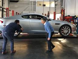Renald en Anton van Dijke nemen de schade aan de James Bond wagen op.