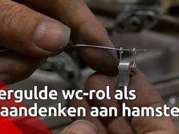 Vergulde wc-rol als hangertje en als aandenken aan het hamsteren van wc-papier 