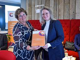 Annemieke de Groot (C-support) overhandigt het rapport aan minister Fleur Agema, rechts (foto: C-Support). Geheel links Alfons Olde Loohuis.