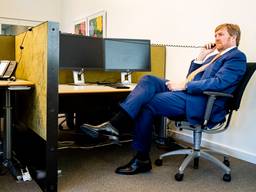 Willem-Alexander aan telefoon bij het callcenter van de GGD. Foto: ANP