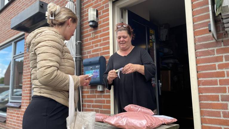 Een klant levert haar pakketjes in bij Monique (foto: Rochelle Moes).