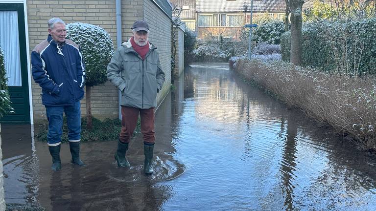 Tuinen, fietspaden en grasvelden onder water door gesprongen leiding