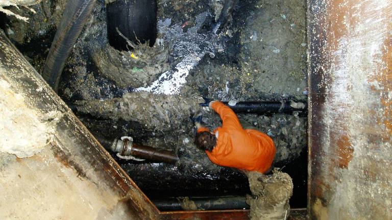 Een medewerker van het waterschap aan de slag in het gemaal