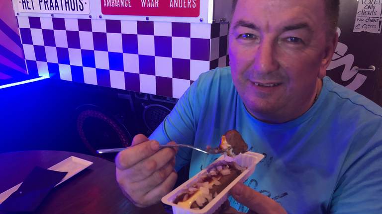 Uitbater Frans Damen eet een frikandel in zijn Hollandse café in Spanje.