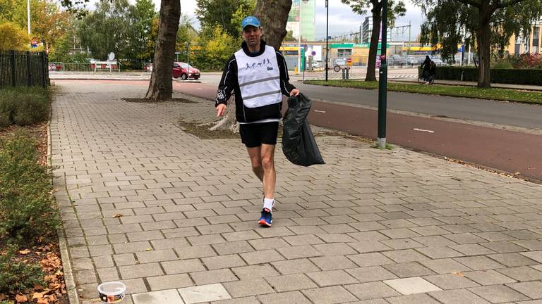 Gewapend met een vuiniszak ruimt Marc Lensen afval op tijdens de Plogging Run. (Foto: Imke van de Laar.)