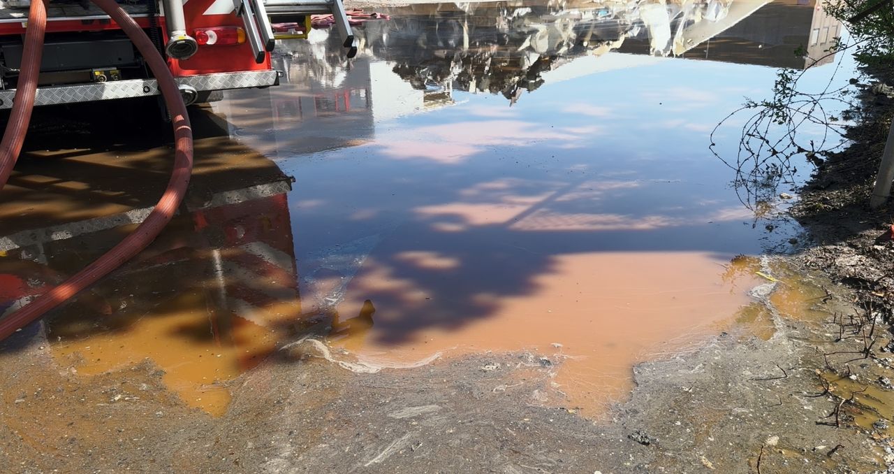 Bruin bluswater stroomt van terrein van Vice Versa (foto: Jan Peels).