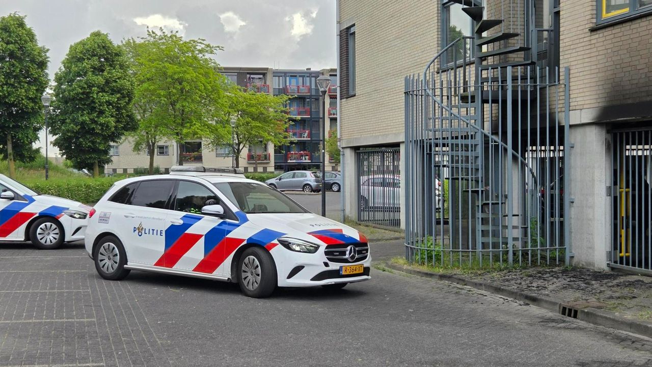 Agenten bewaken de uitgebrande auto's (foto: Noël van Hooft).