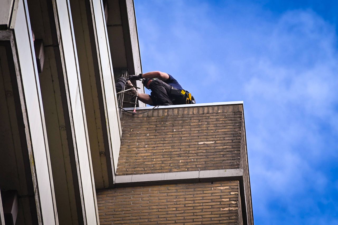 Een agent van de DSI klimt op de galerij (foto: Persbureau Heitink).