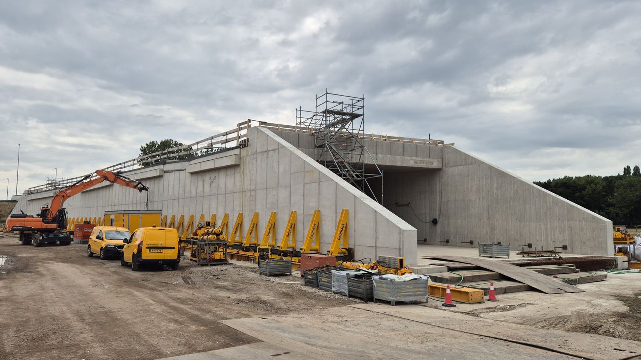 Hefwerktuigen aan de constructie tillen het gevaarte op rails (foto: Niek de Bruijn)