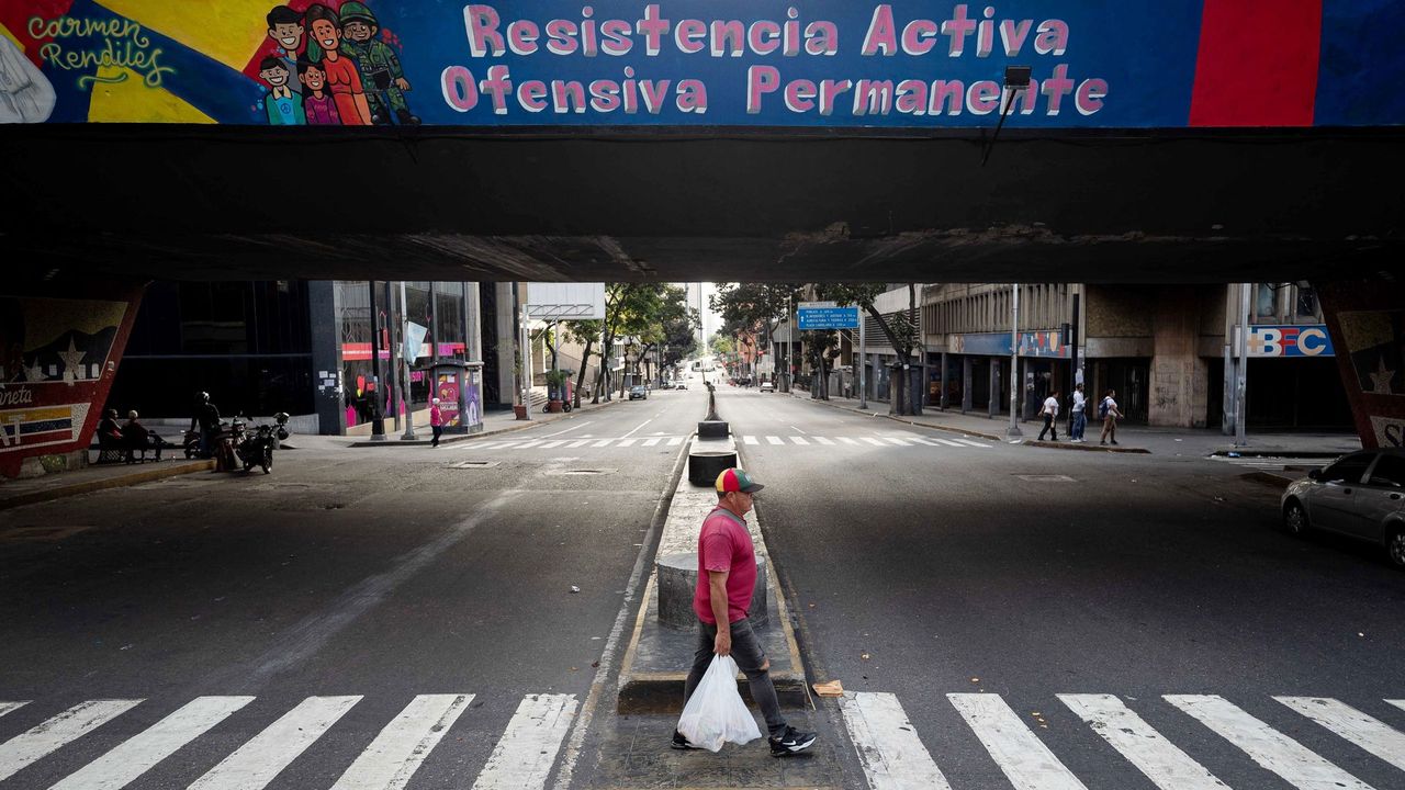 Een enkeling loopt over straat - EPA