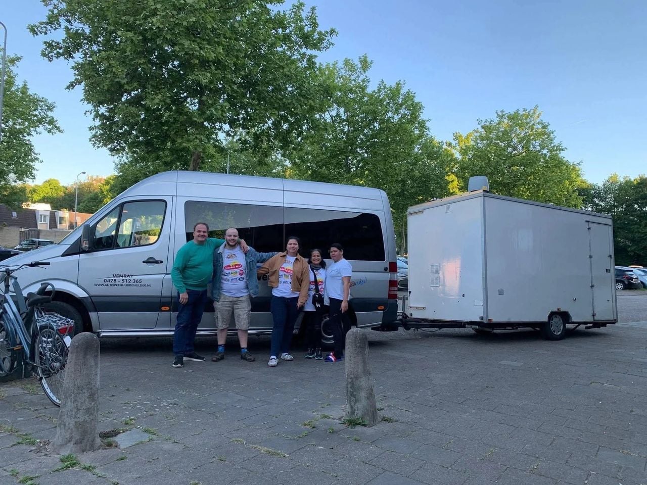 Carina, Ronald en familie bij de foodtrailer en het busje (foto: familie Bunschoten-Lopez).