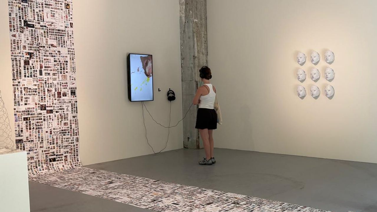 Een bezoeker kijkt naar het digitale werk van Zari (foto: Loïs Verkooijen). 