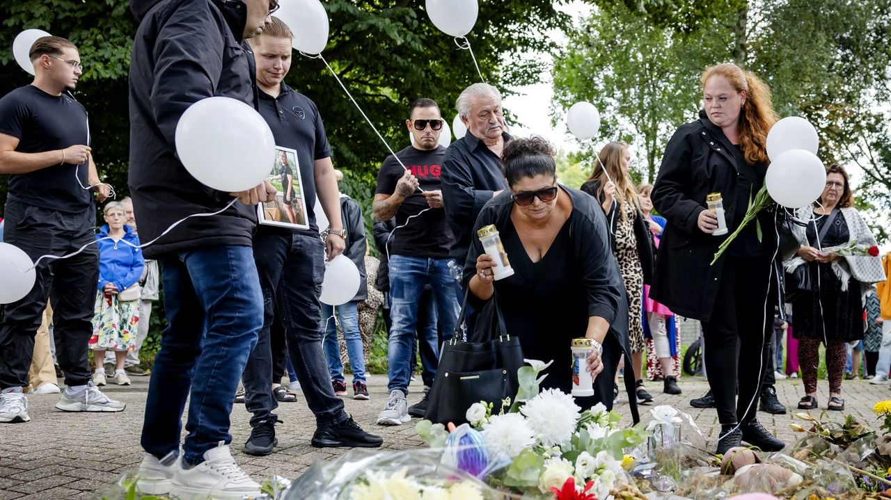 deelnemers aan de stille tocht lopen met witte balonnen en leggen bloemen neer op de plek waar Joeweela werd gedood (ANP). 