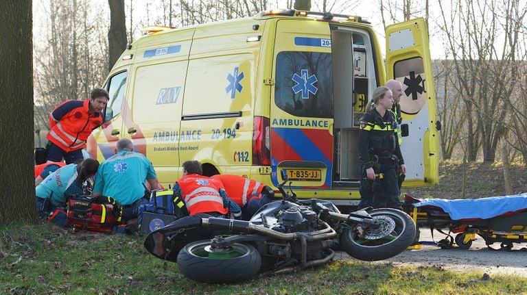 Ambulance en agenten buigen zich over het slachtoffer (foto: Jeroen Stuve/Persbureau Heitink).