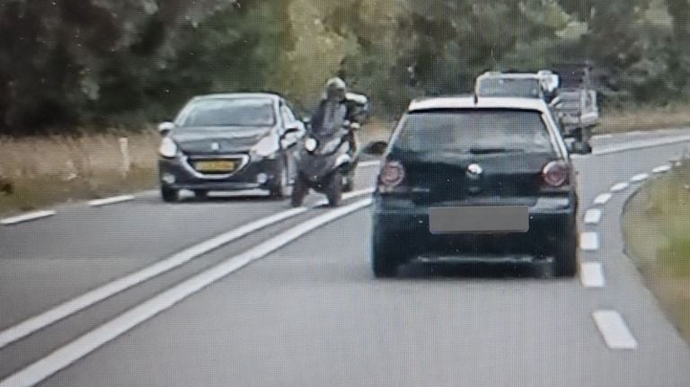 De bestuurder van de MP3 (midden) betrapt (foto: Verkeerspolitie Oost-Brabant).