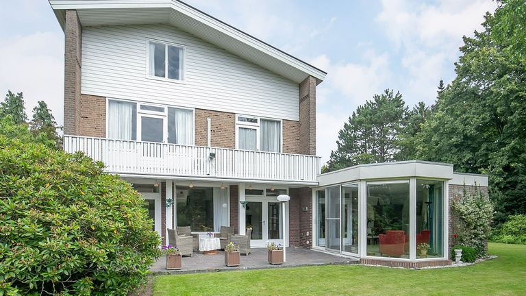 De tuinkamer en het terras van buitenaf (foto: Bato Makelaars en Woningadviseurs).