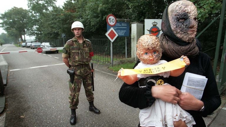 Een demonstante als atoom-nepslachtoffer verlaat de poort van vliegbasis Volkel in 1998 (foto: ANP).