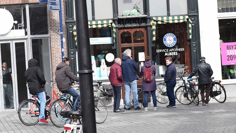 Een rij voor de apotheek, beurtelings naar binnen (foto: Henk van Esch)