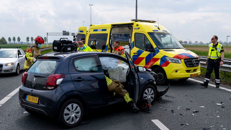 De brandweer hielp de man uit de auto (foto: Marcel van Dorst/SQ Vision). 