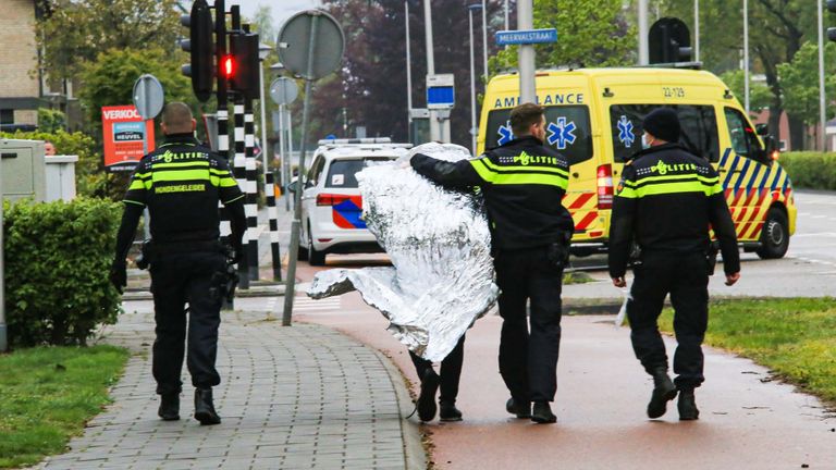 Een van de aangehouden verdachten wordt door de politie meegenomen (foto: Harrie Grijseels / SQ Vision).